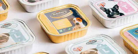 Pet food tins arranged on a surface
