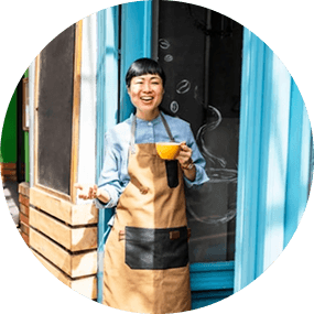Retailer standing at the door of their shop