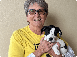 Volunteer holding a puppy